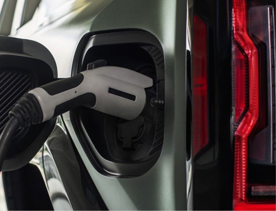 Close up of charging port with charger plugged in on a GMC Hummer EV SUV - Gem City Motors GMC in Sidney MT